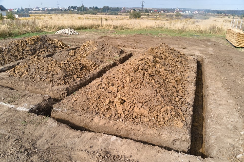Dug trench materials being used to reinforce earth structures 